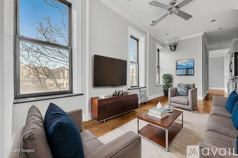A living room with a brown couch and a flat screen TV.