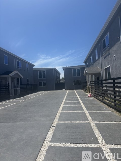 A row of houses with a driveway in front.