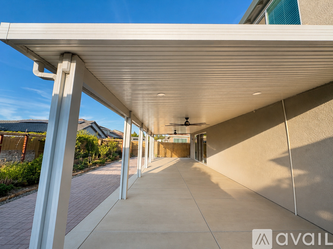 A long, covered walkway leads to a building entrance.