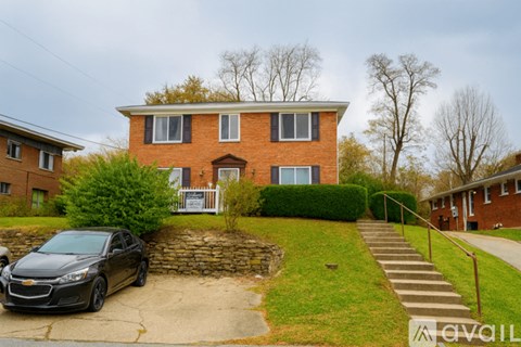 A house with a car parked in front.