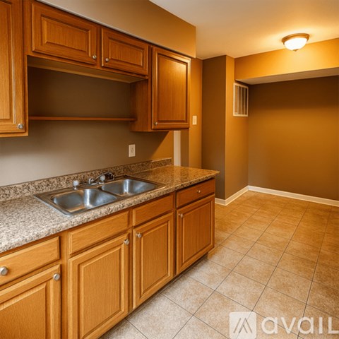 A kitchen with brown cabinets and a granite countertop.