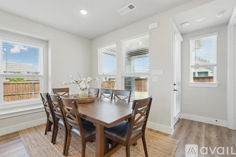 A dining room with a table set for four.
