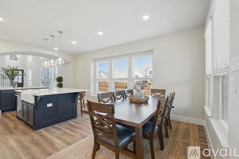 A modern kitchen with a dining table set for four.