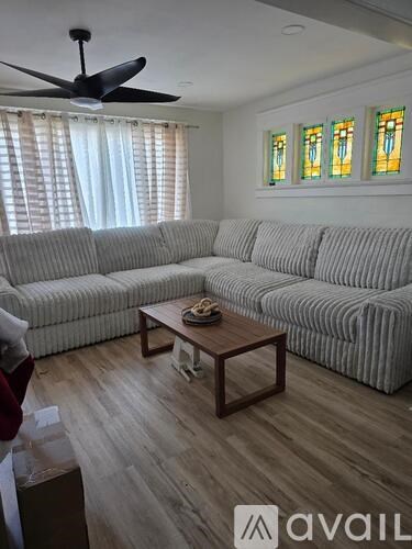 A living room with a striped couch and a coffee table.