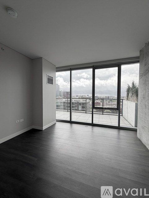A spacious room with large windows overlooking a cityscape.