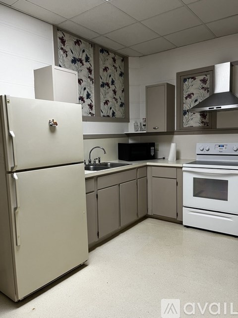 A kitchen with a white refrigerator and a white oven.