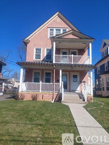 A two-story house with a front porch.