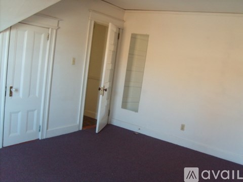 A room with a white door and a white wall.