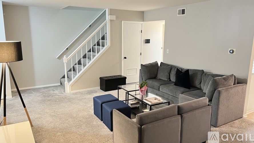 A living room with a grey couch and a coffee table.