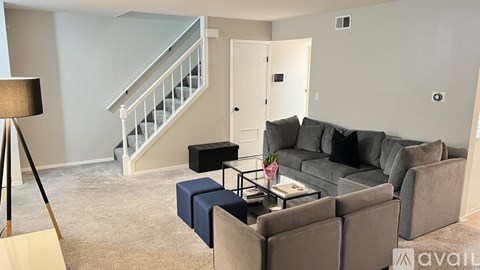 A living room with a grey couch and a coffee table.