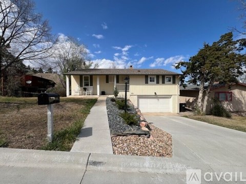 A house with a front yard and a mailbox.