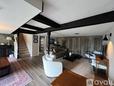 A living room with a white sofa and a wooden coffee table.