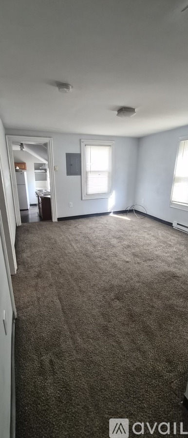 A room with carpeted floor and a window.