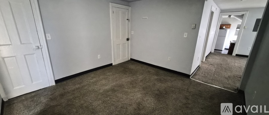 A room with carpeted floor and white walls.
