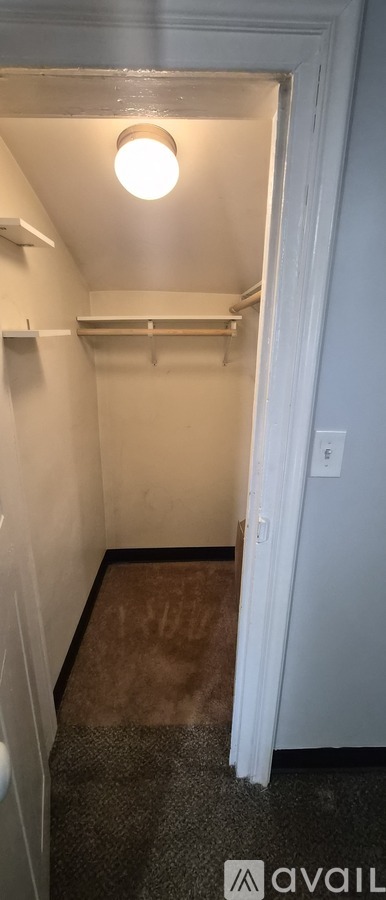 A small, empty room with a light on.