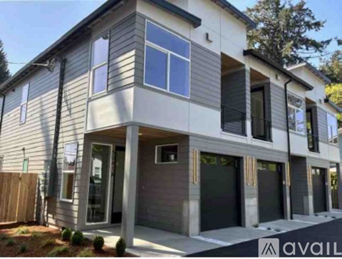 A modern two-story house with a garage is available for sale.