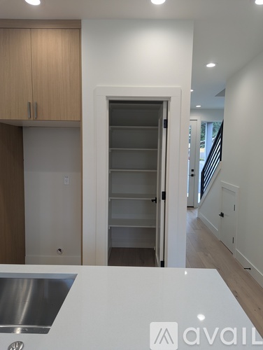 A kitchen with a sink and a refrigerator with a logo on it.