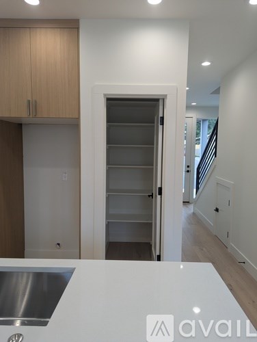 A kitchen with a sink and a refrigerator with a logo on it.