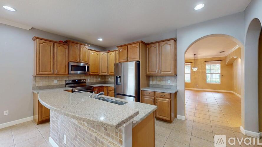 A kitchen with wooden cabinets and a granite countertop.