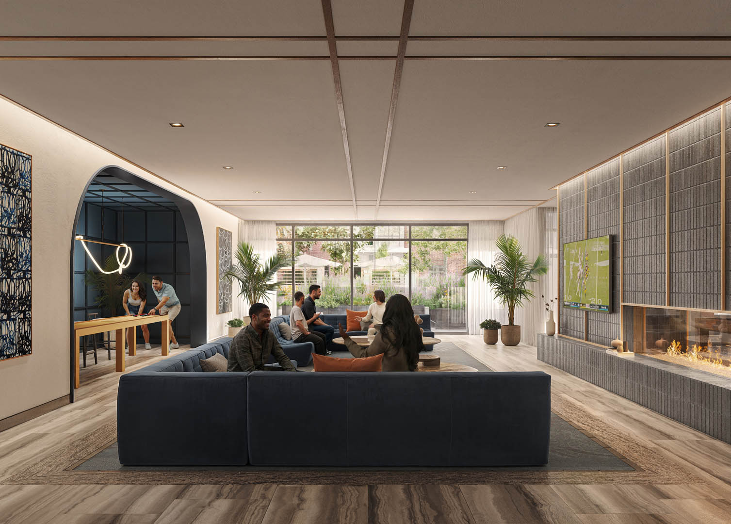 A modern living room with people sitting on a couch and a fireplace on the right side.