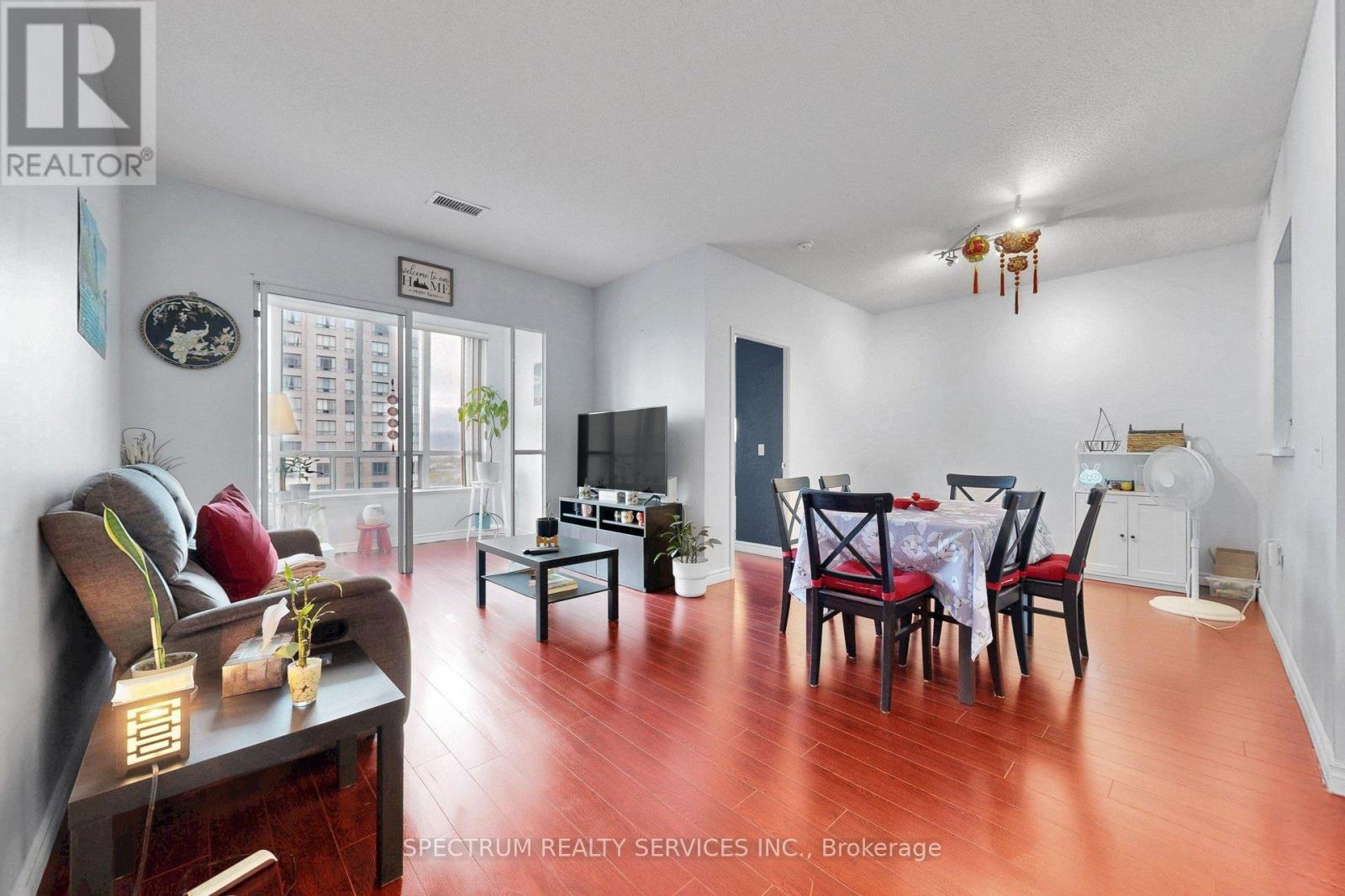 A living room with a dining table and chairs.