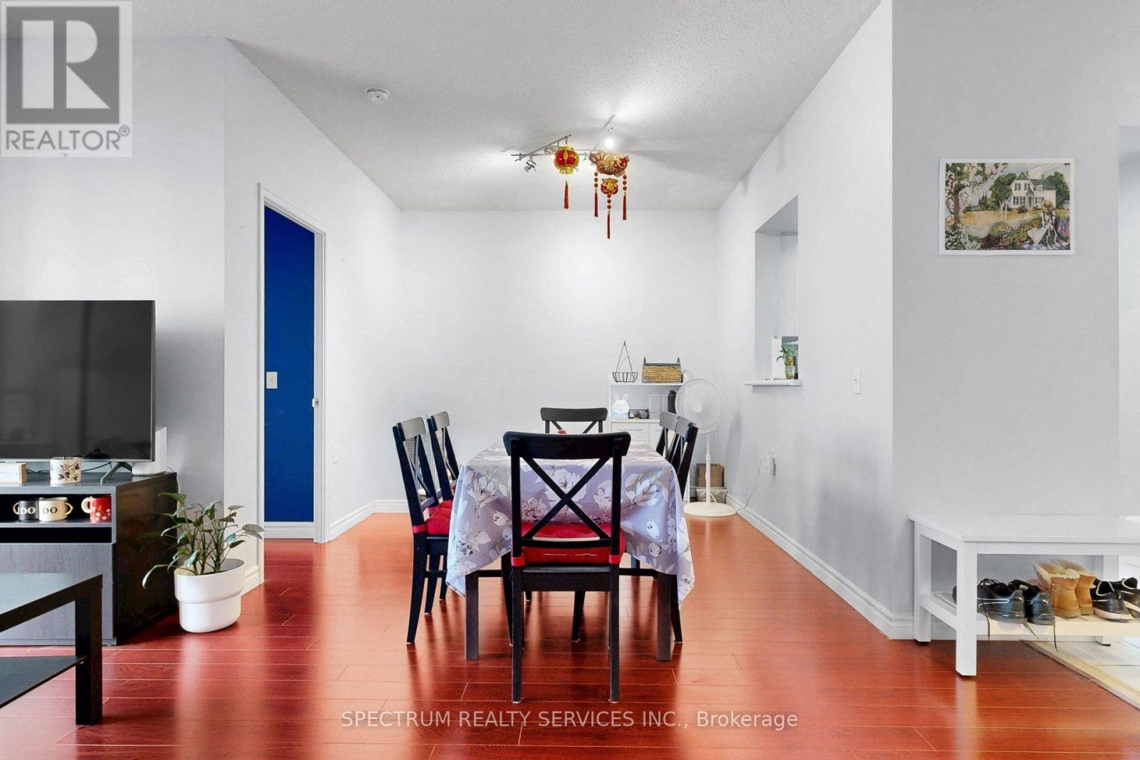A dining room with a table set for four.