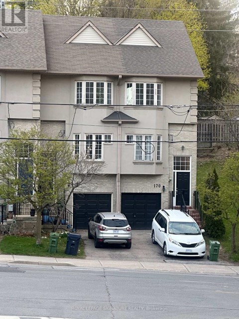 A two-story house with a garage and a car parked in front.