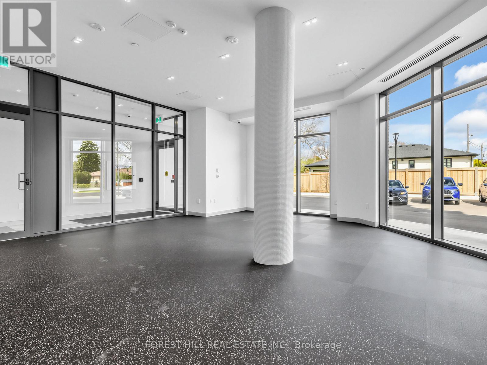 A spacious office with large windows and a view of the outdoors.