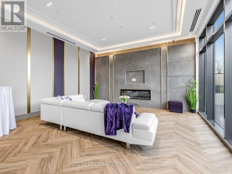 A modern living room with a white sofa and a wooden floor.