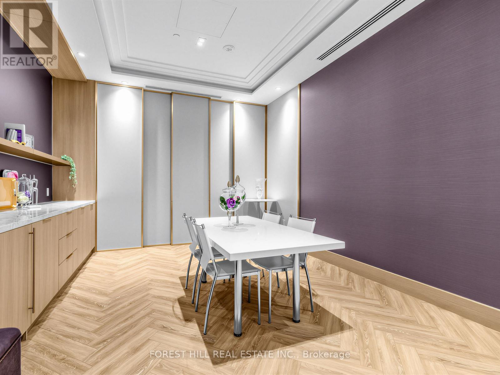 A dining room with a white table and chairs.