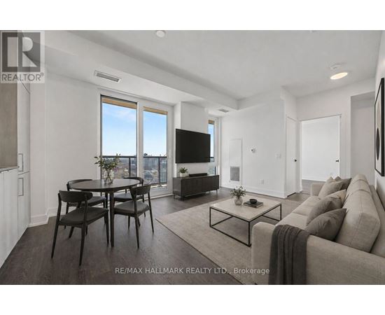 A modern living room with a large window and a flat screen TV.
