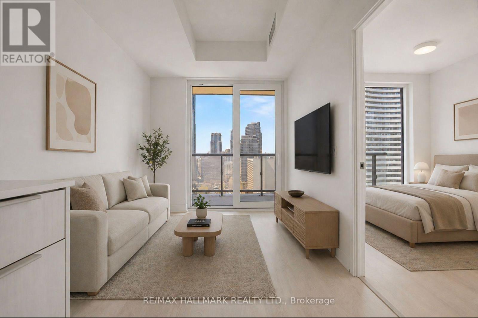 A living room with a large window overlooking a cityscape.