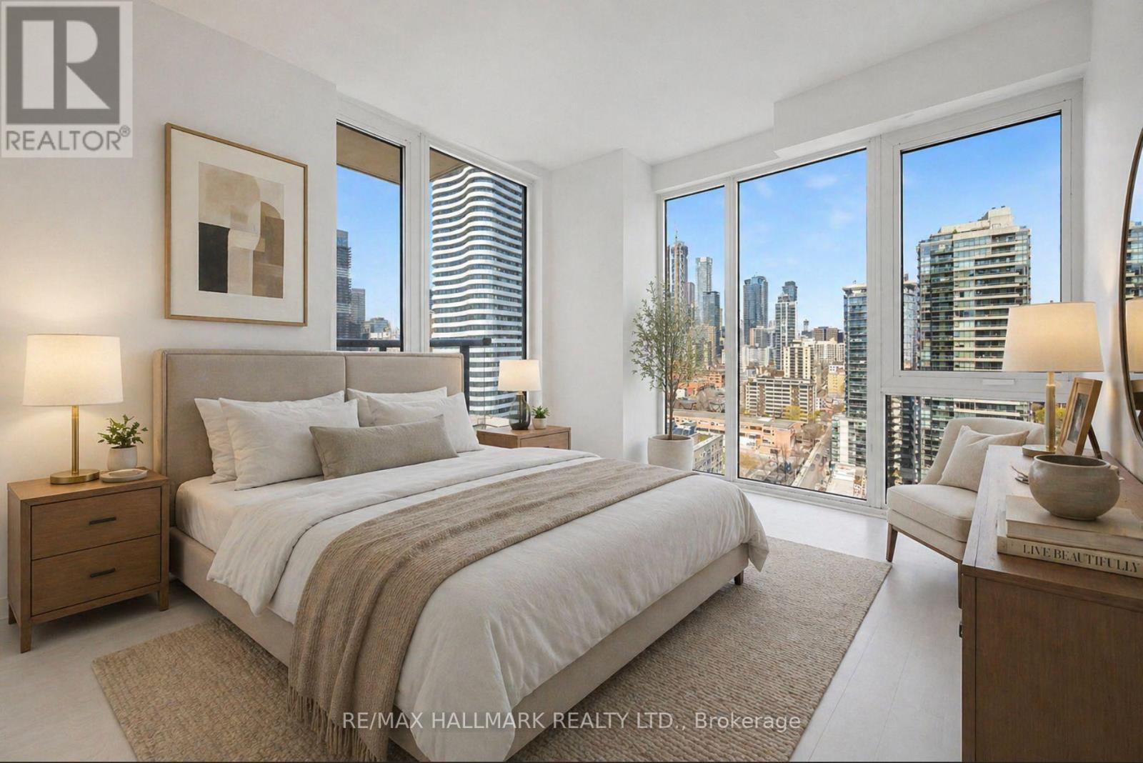 A bedroom with a large bed and a view of the city.