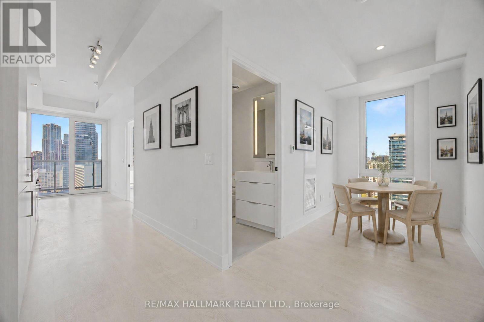 A spacious white room with a dining table and chairs.