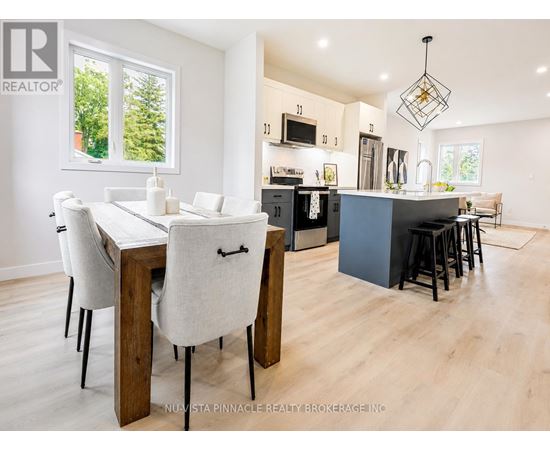 A modern kitchen with a dining table and chairs.
