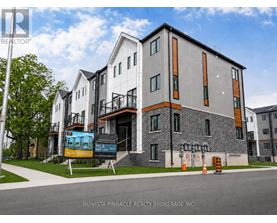 A modern building with a sign that says "Now Renting" in front of it.