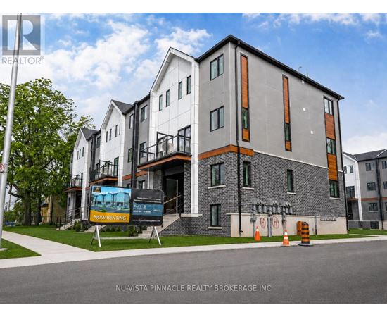 A modern building with a sign that says "Now Renting" in front of it.