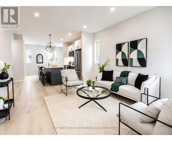 A modern living room with a glass coffee table and a white sofa.