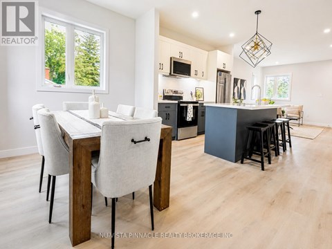 A modern kitchen with a dining table and chairs.