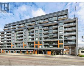 A large multi-story building with balconies and orange accents is for sale.
