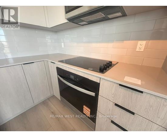 A kitchen with a stove top oven and a microwave above it.