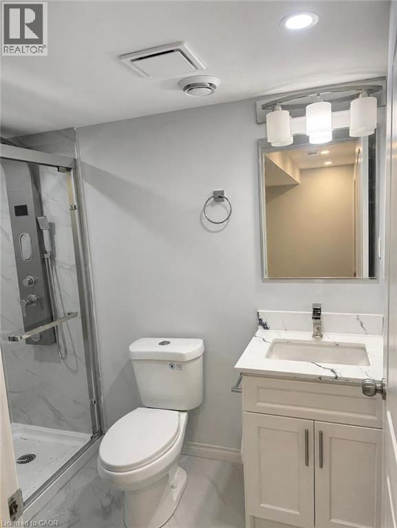 A white toilet sits next to a sink in a bathroom.