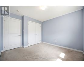 A room with two doors and a carpeted floor.