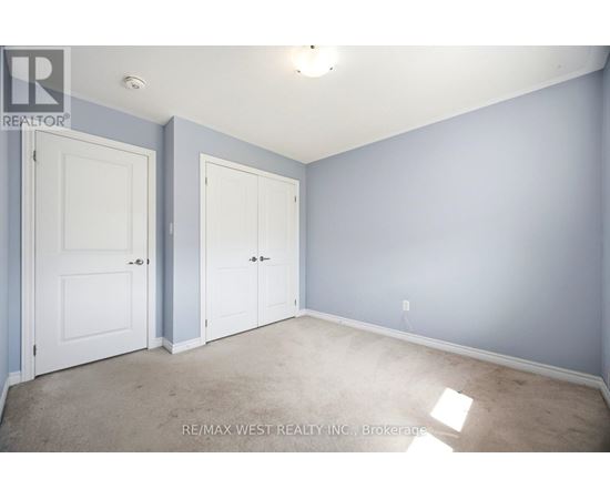 A room with two doors and a carpeted floor.