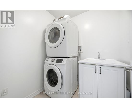 A white washing machine and dryer in a laundry room.