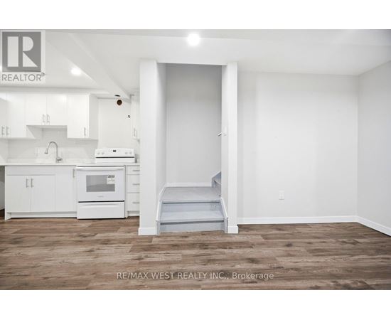 A white kitchen with a microwave and oven.