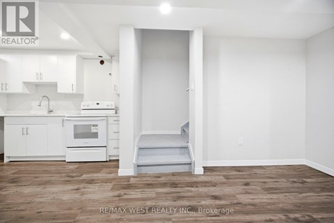 A white kitchen with a microwave and oven.