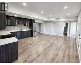 A spacious kitchen with dark wood cabinets and a white countertop.