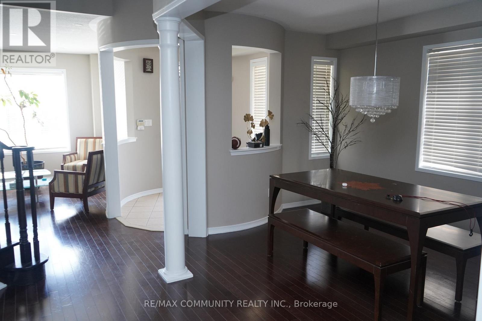 A dining room with a table and chairs.