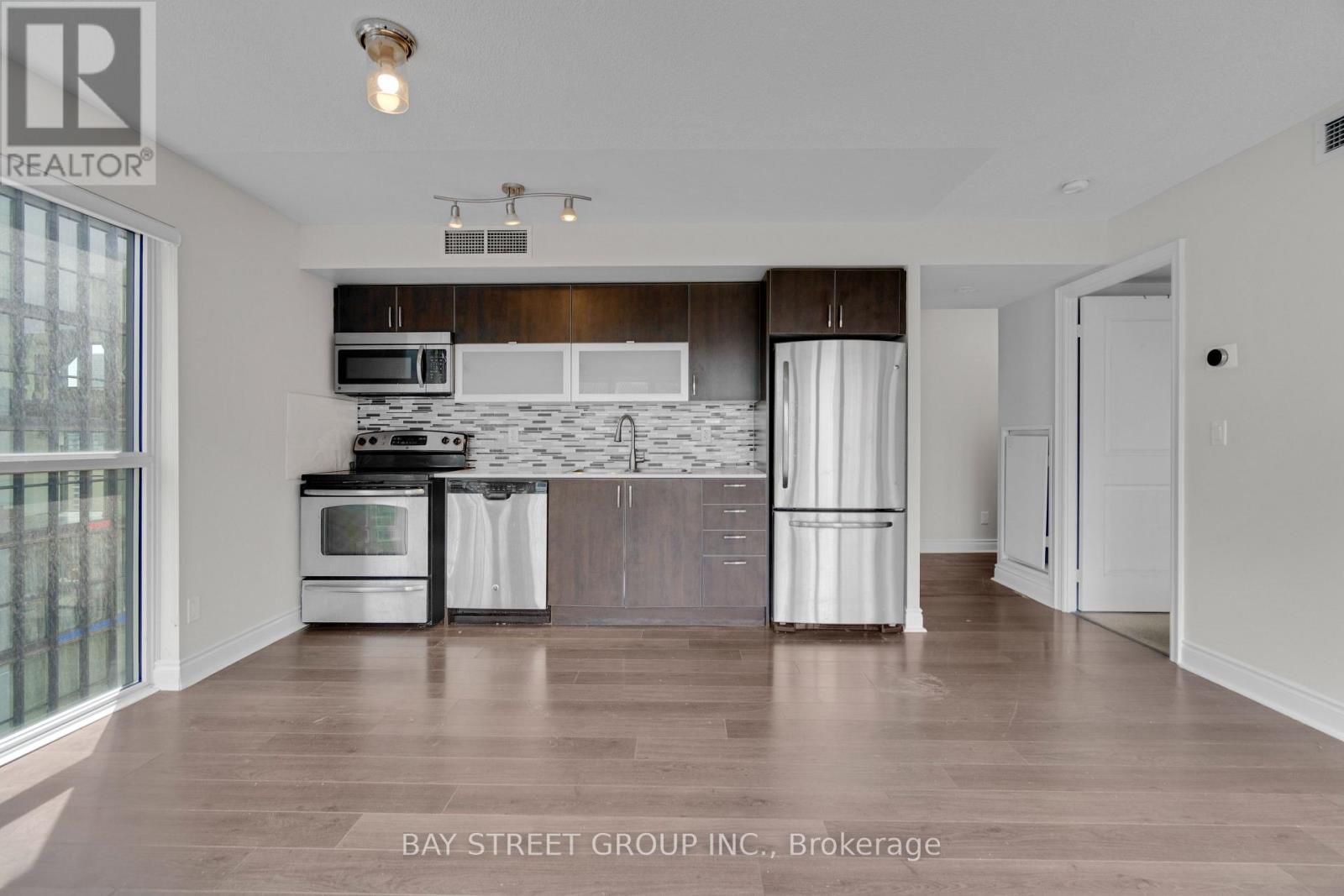 A kitchen with white appliances and a wooden counter top.